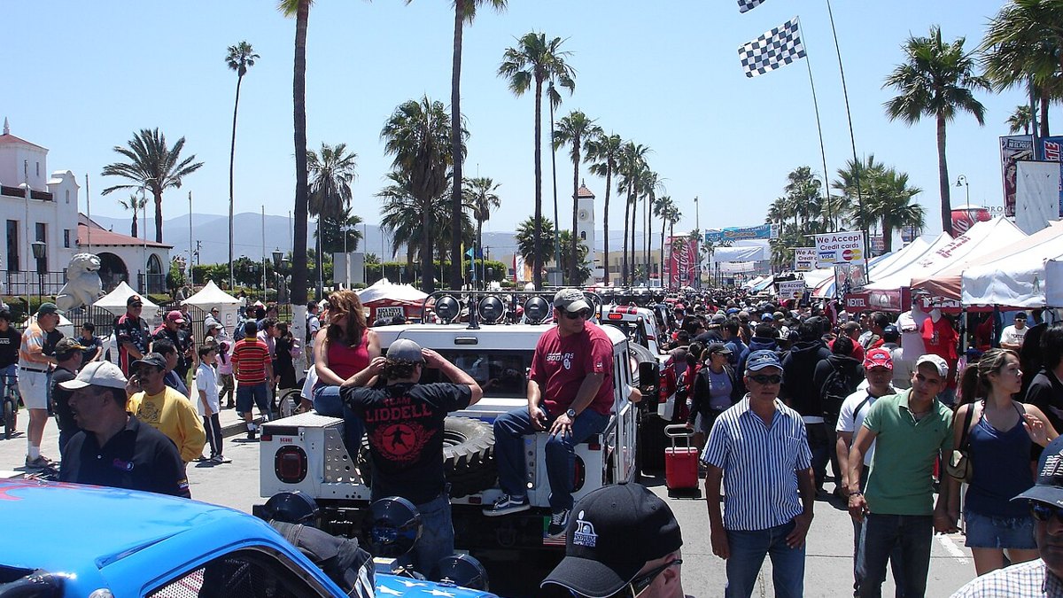 Fans and vehicles at SCORE Baja race contingency and tech