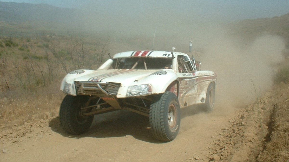 SCORE San Felipe 250: Race Guide & Mexican Insurance 2 A trophy truck racing through the Baja desert kicking up dust